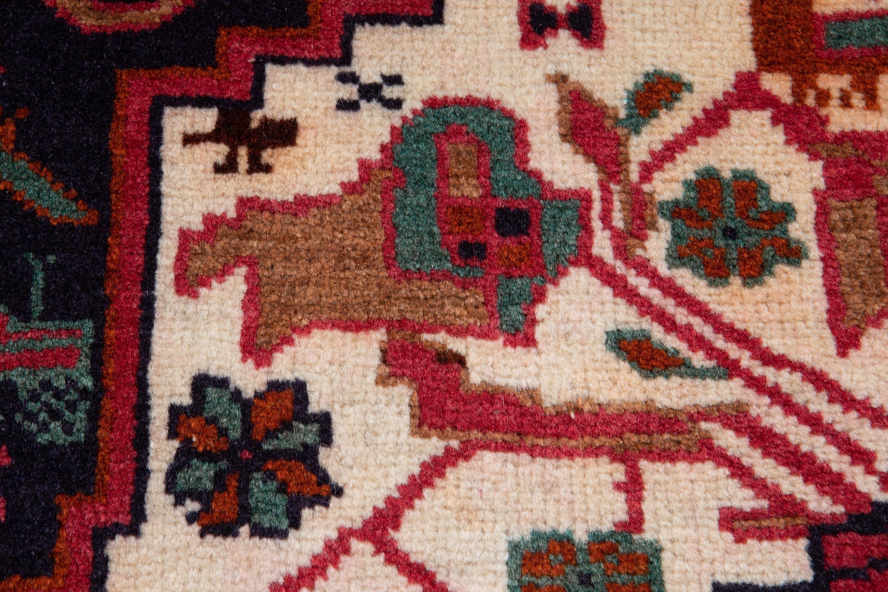 Close-up of a corner showing an animal figure and floral motifs woven into the design.