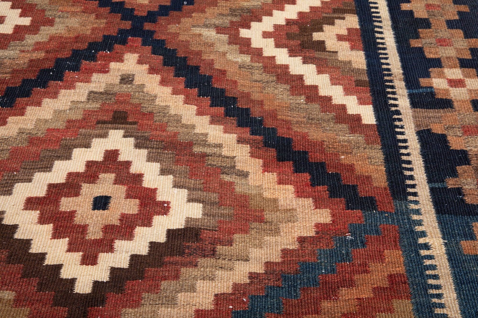 Extreme close-up of a diamond medallion showing the tightly woven flatweave texture.