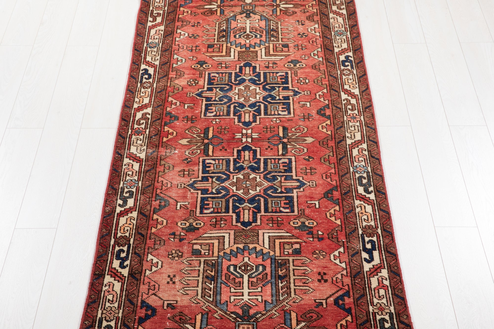Center section of Hand-Knotted Antique Wool Runner Rug – 14' 9" x 3' 4" featuring symmetrical tribal motifs and bold color contrasts.