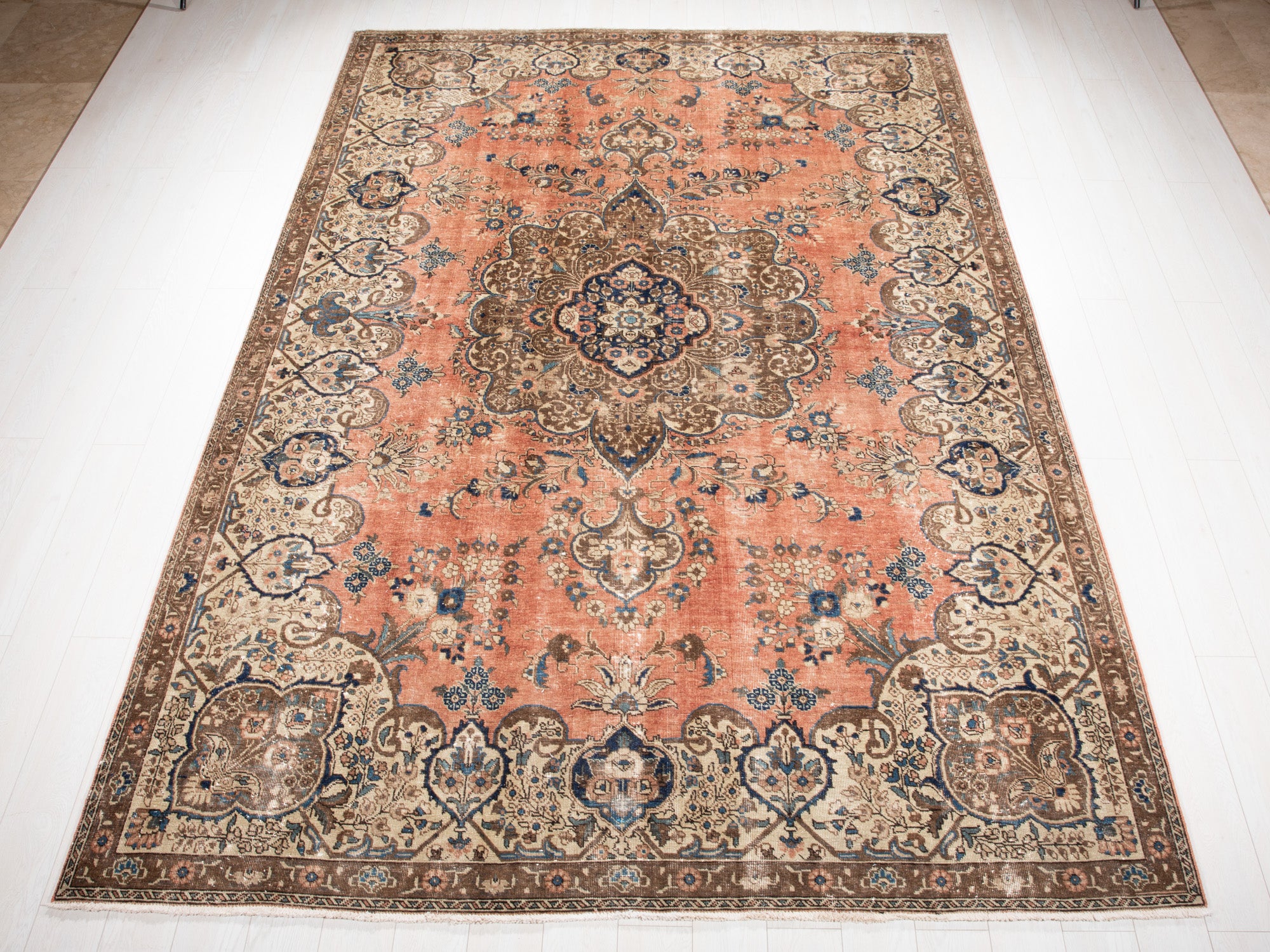 Hand-knotted vintage large wool area rug faded in peach and beige tones, measuring 10'10" x 7'6", ideal for classic home decor.