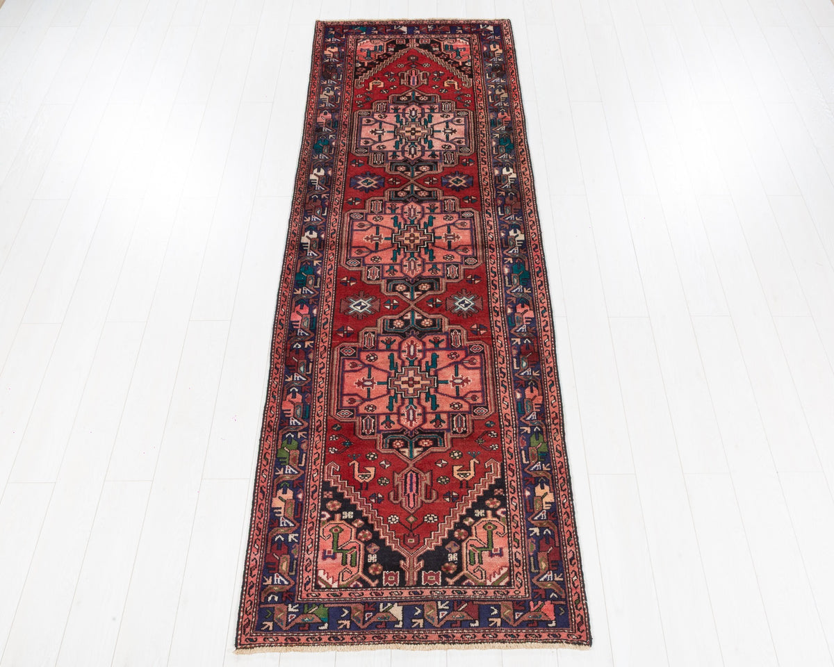 Vintage Hamadan runner with red field, coral pink geometric medallions and navy blue border, SKU 5136