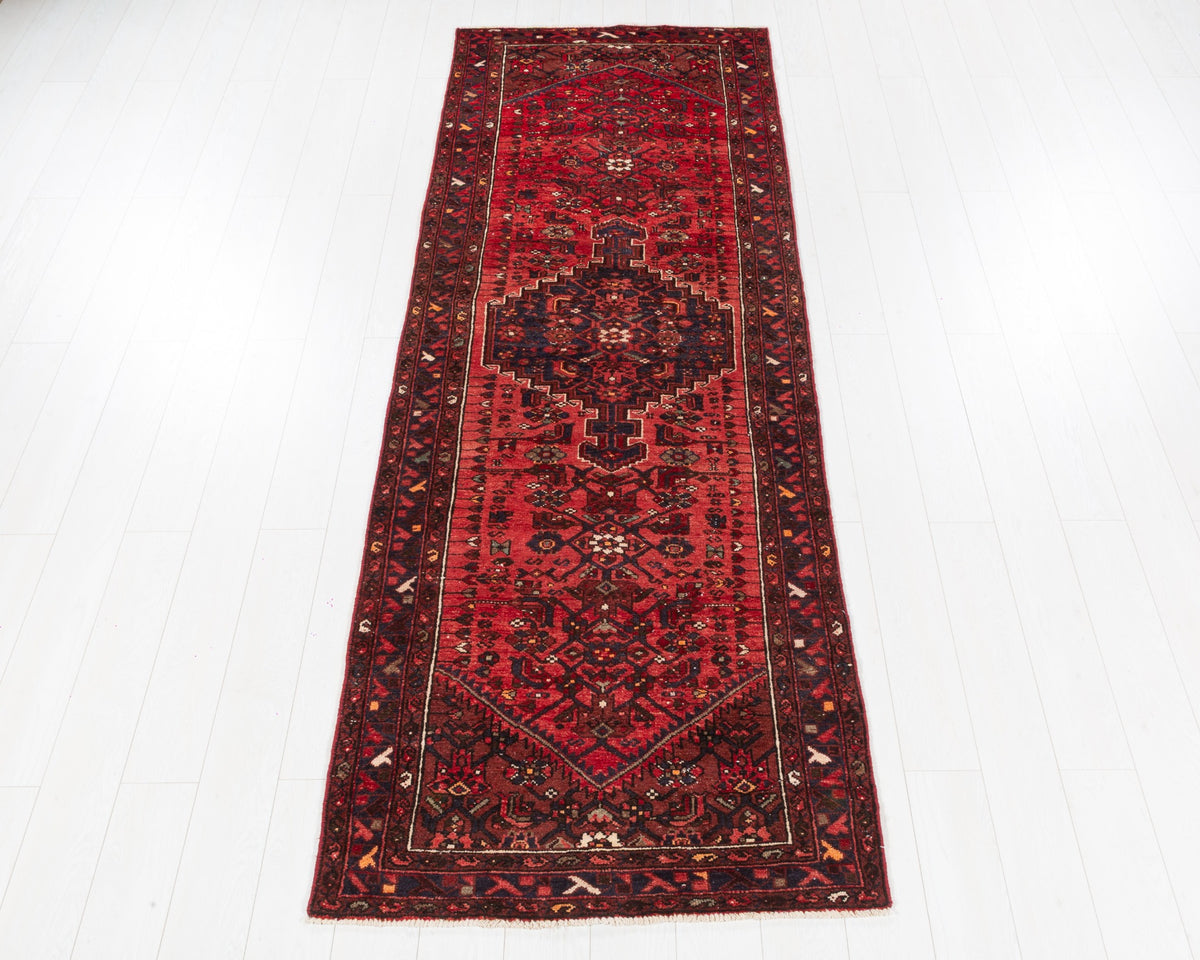 Vintage Zanjan runner with rust red field and dark navy stepped medallion, SKU 5137