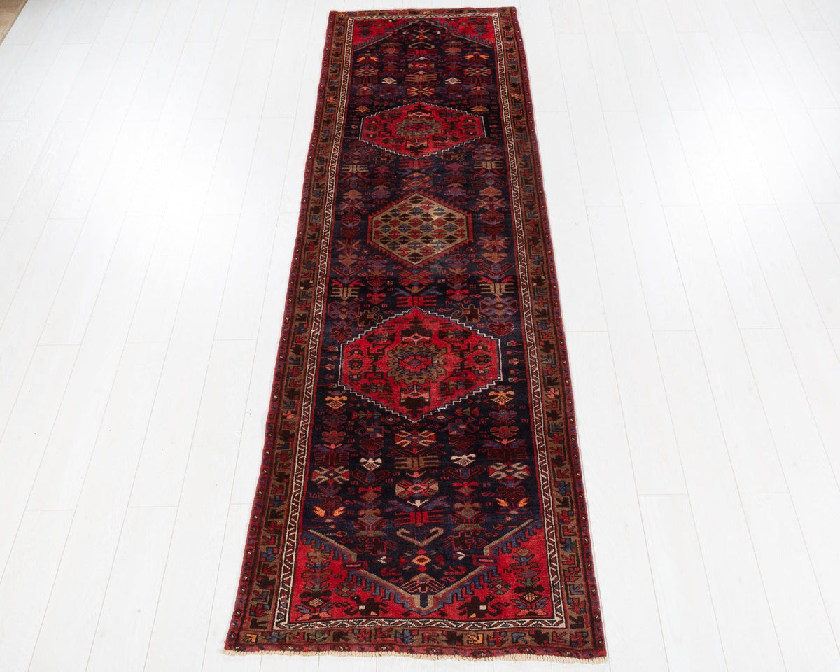 Vintage Hamadan runner with deep navy field, red medallions and camel central medallion, SKU 5143