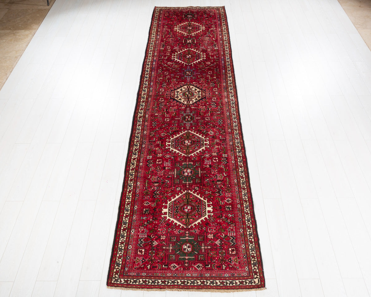 Fine vintage Gharajeh Heriz runner with red field, green geometric motifs and eleven geometric medallions, SKU 5145