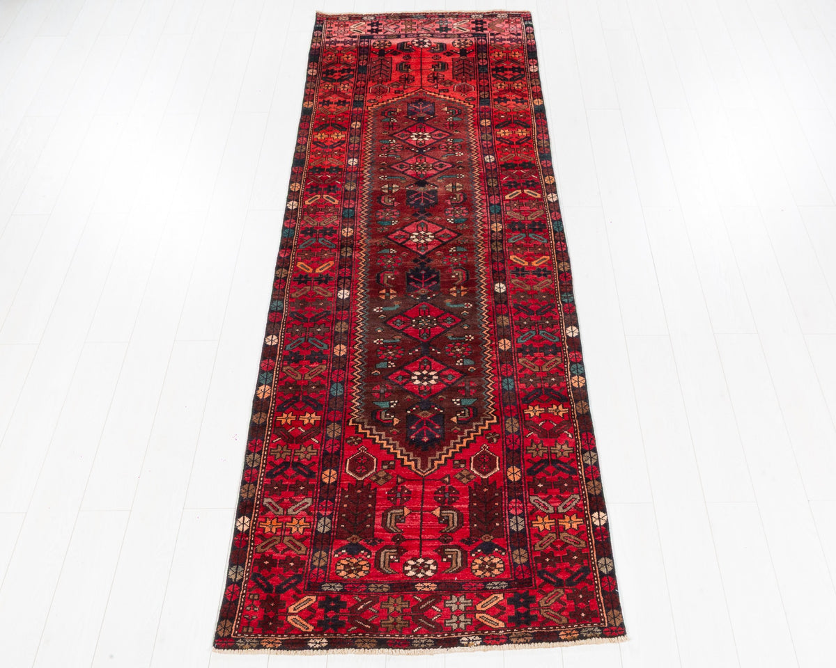 Vintage Zanjan runner in rich red and muted rust tones with geometric tribal design, SKU 5162