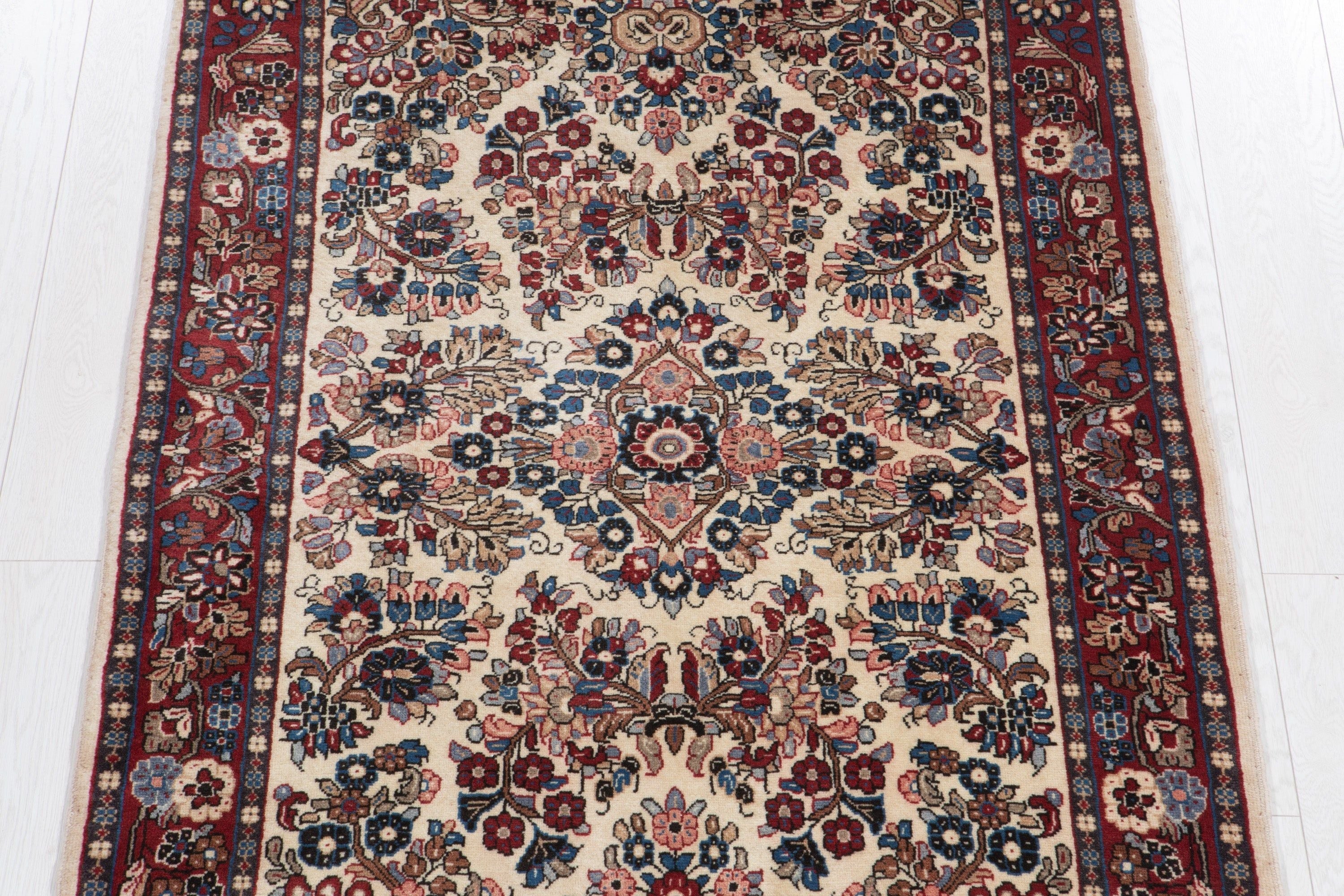 Top-down view of the rug showing the full floral medallion pattern and red border.