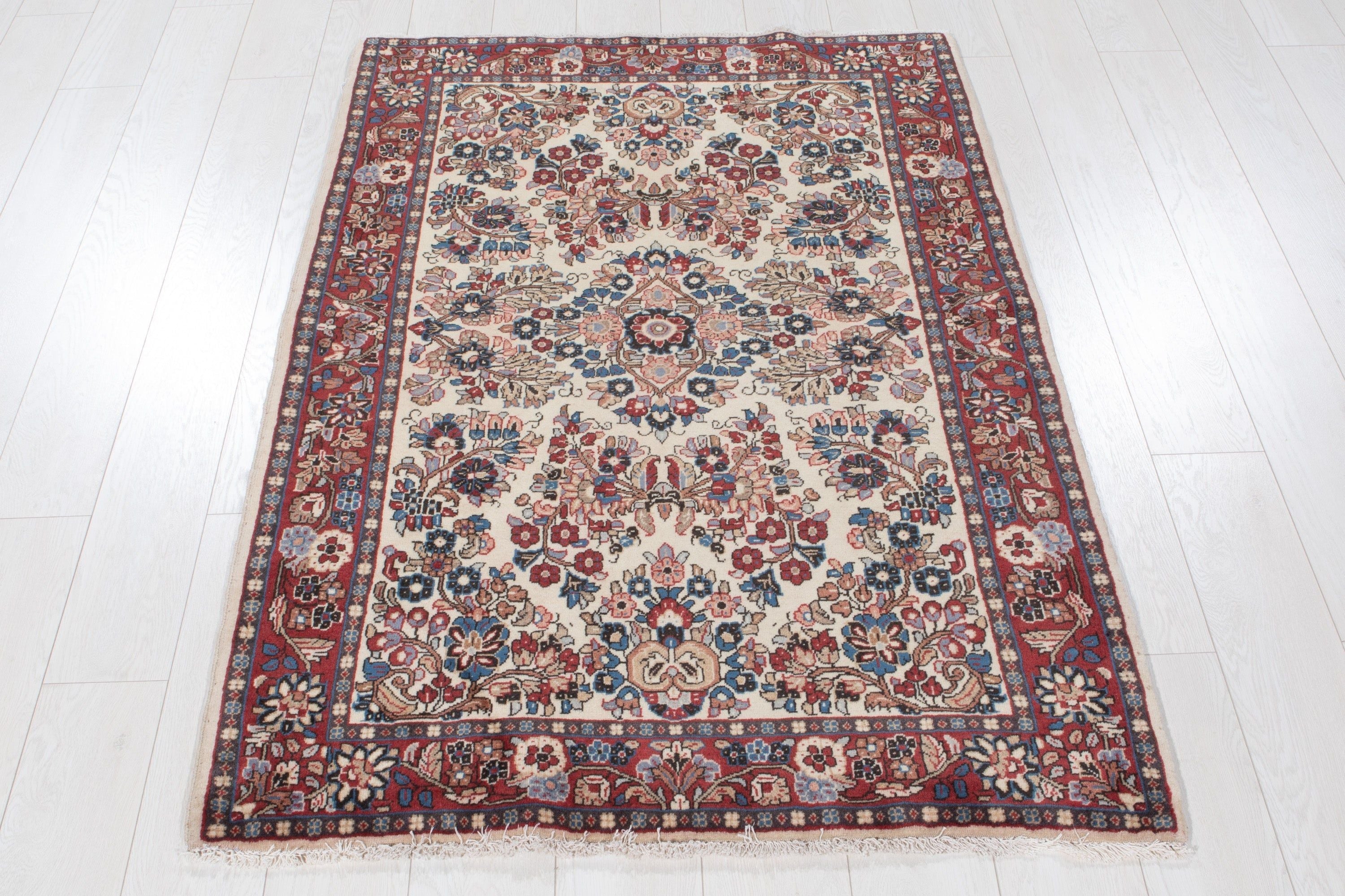 Full-length view of the rug on a wood floor with fringe visible at both ends.