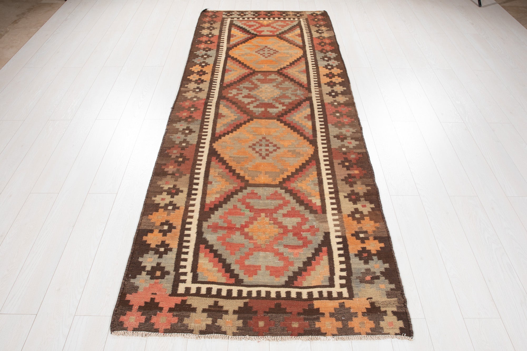 Full-length view of the antique Persian kilim runner from the opposite end.