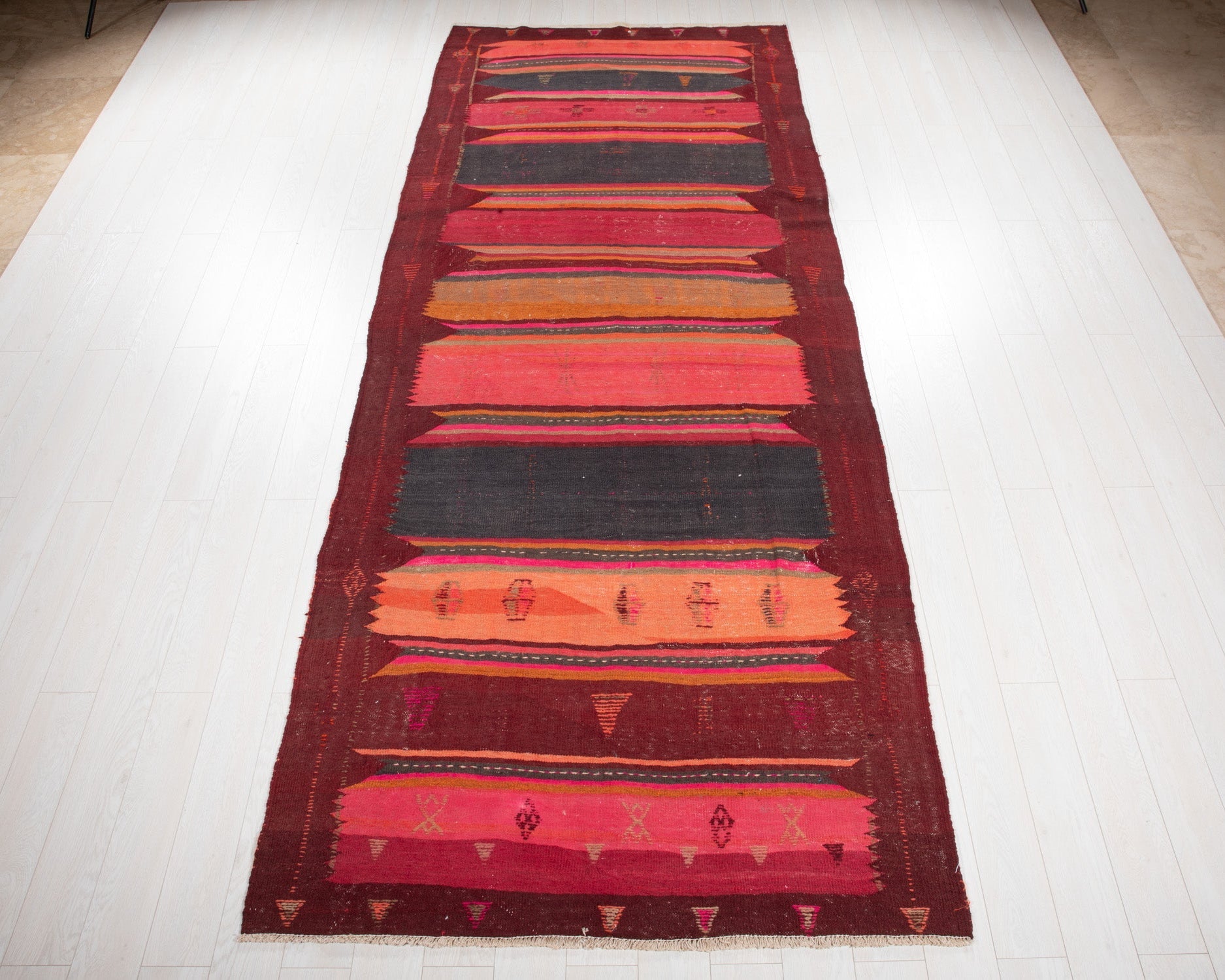 Full view of the vintage Persian Shiraz kilim rug in a colorful midcentury striped design.