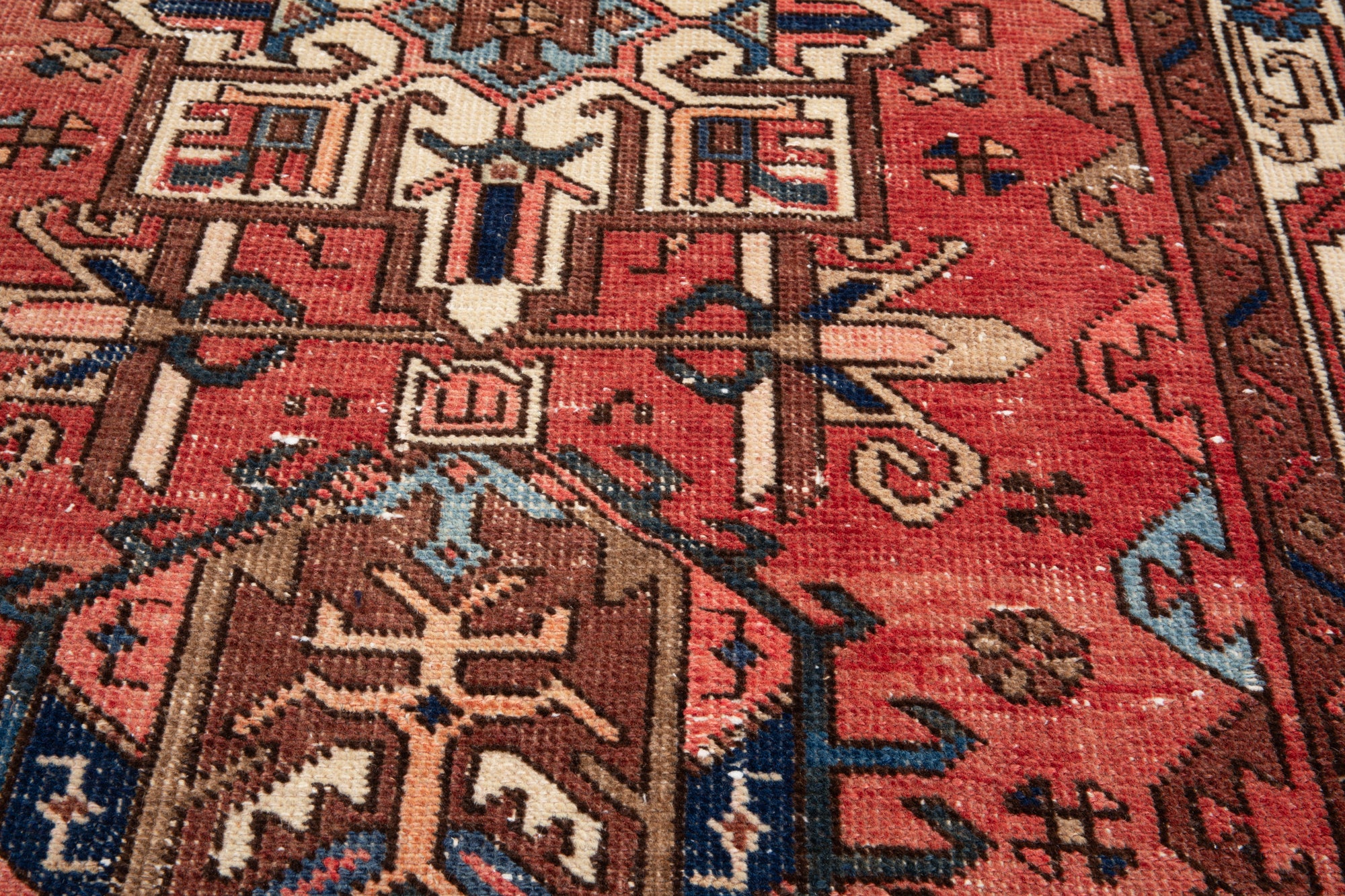 Macro shot of Hand-Knotted Antique Wool Runner Rug – 14' 9" x 3' 4" showing fine knotting and complex tribal patterns in red and blue.
