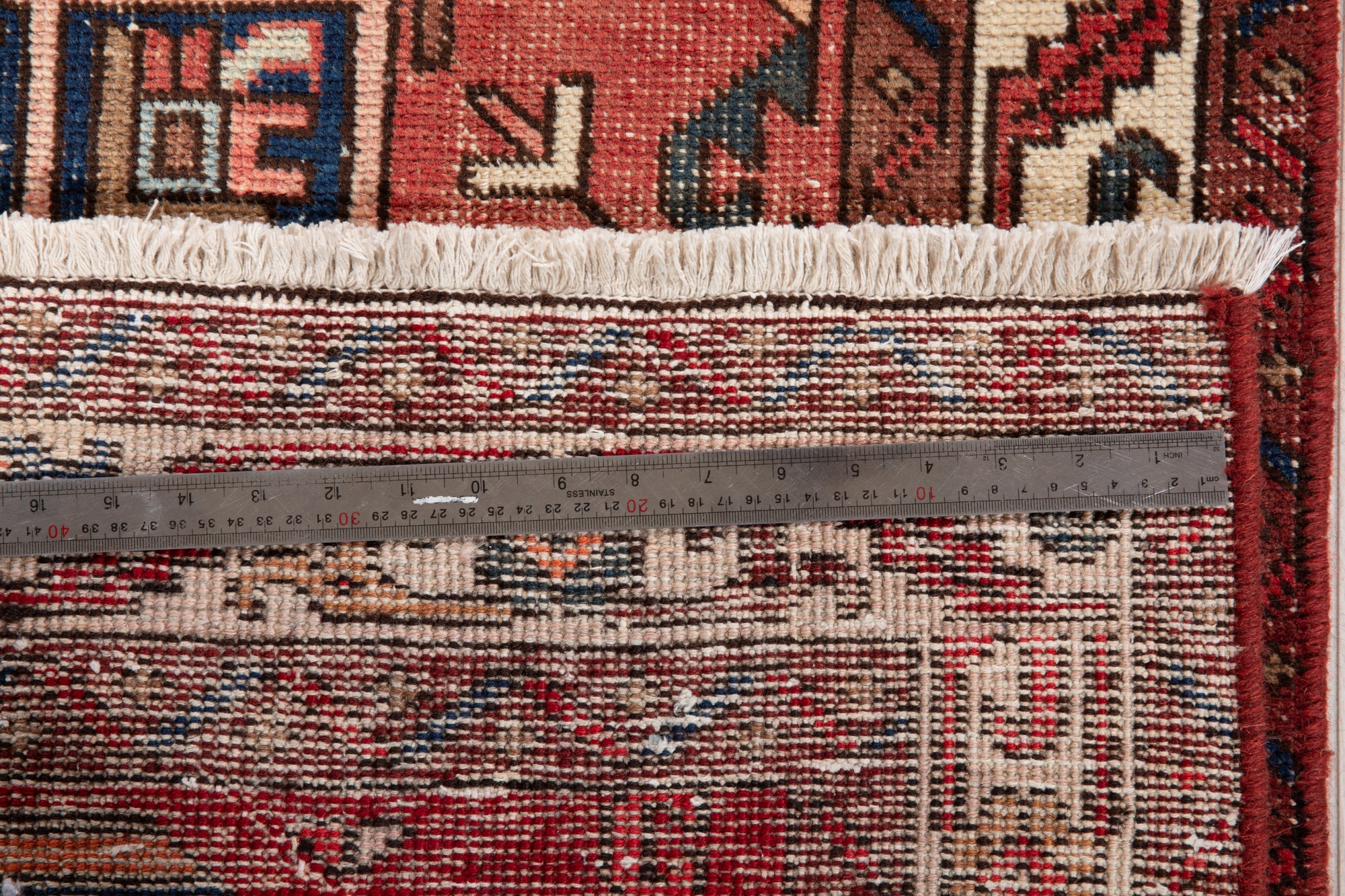 Close-up of fringe and back of Hand-Knotted Antique Wool Runner Rug – 14' 9" x 3' 4" with ruler for scale, showcasing knot density.