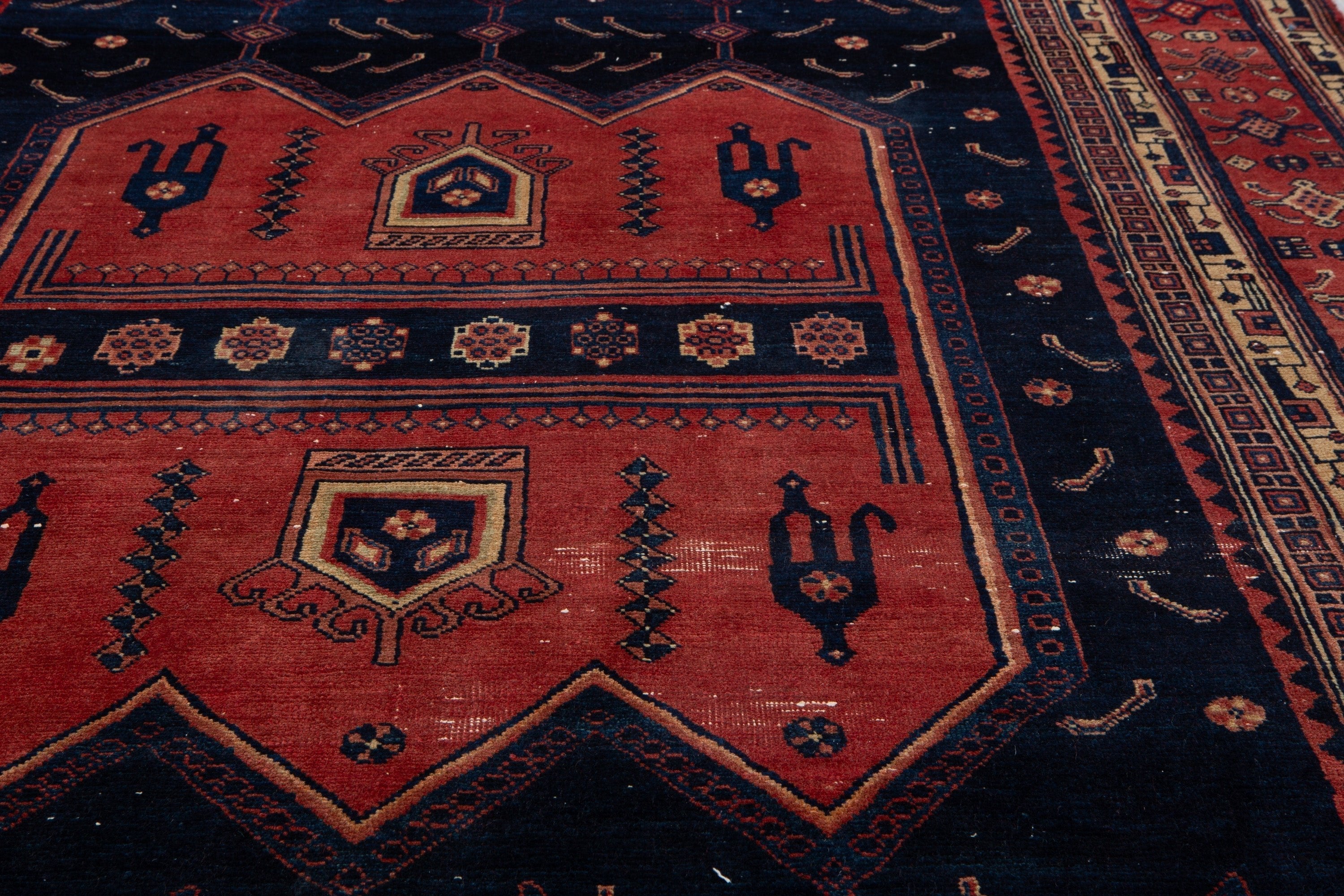 Extreme close-up of a central medallion with bird motifs beside the woven border pattern.