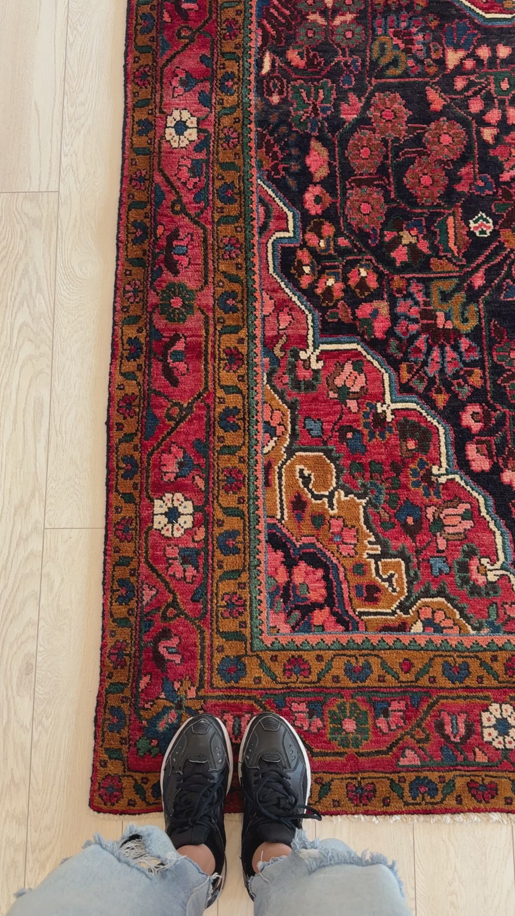 Close-up of the corner of the Hand-Knotted Vintage Wool Area Rug – 10' 10" x 5' 7" showing detailed floral border and rich color palette.