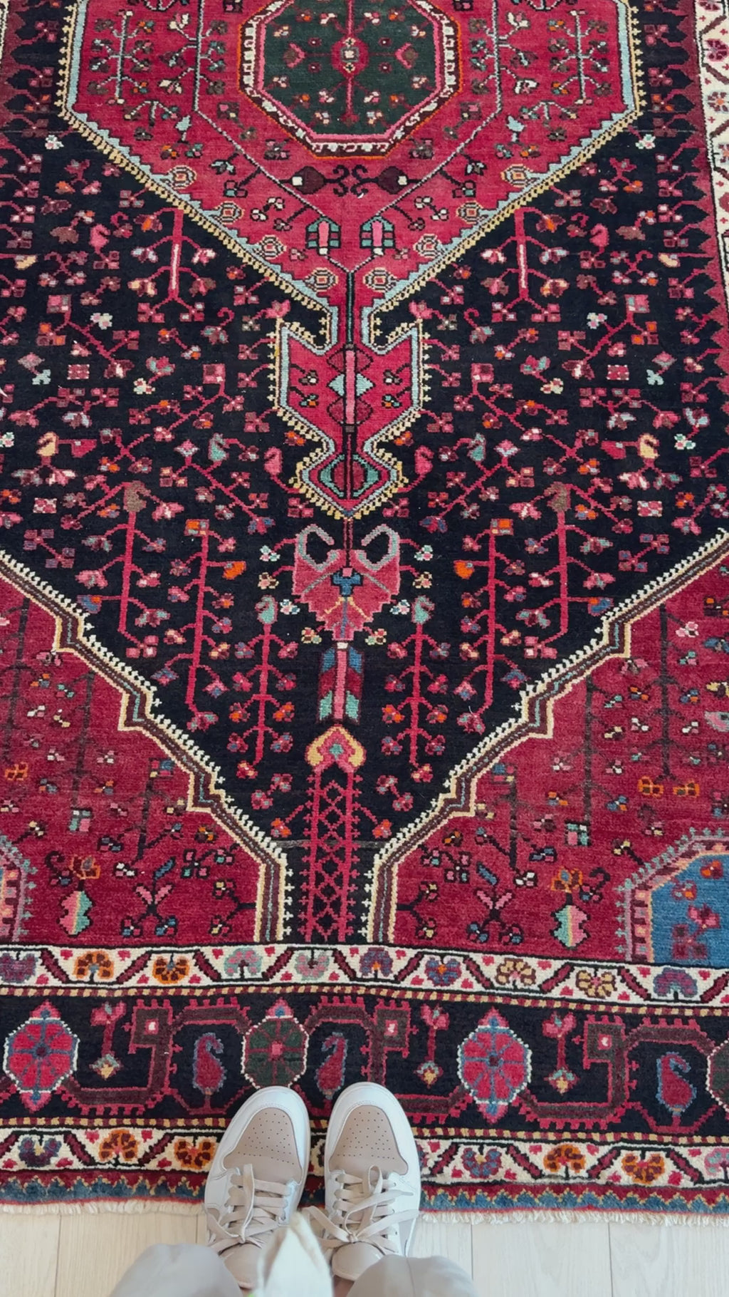 Close-up of Hand-Knotted Vintage Wool Area Rug – 9' 10" x 5' 1" showing detailed red and black motifs and fine wool texture.