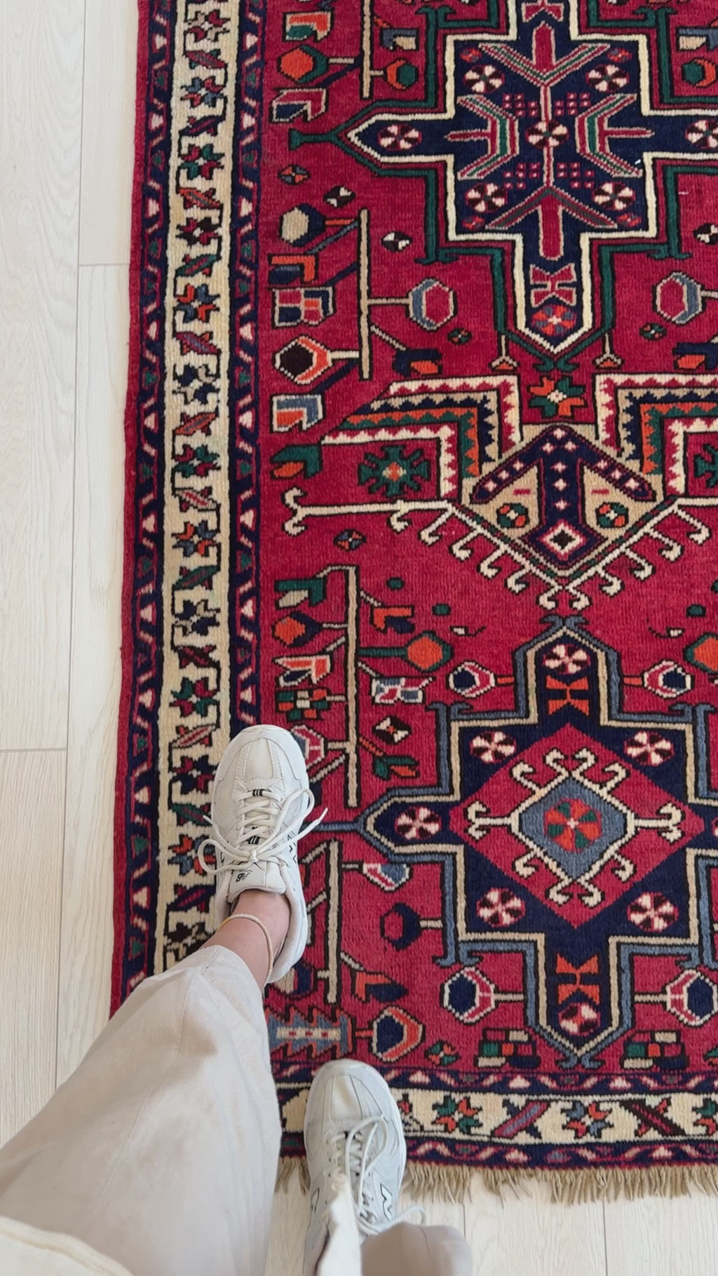 Close-up of hand-knotted vintage wool runner rug 10' 4" x 3' 4" highlighting detailed border and vibrant red and navy design.