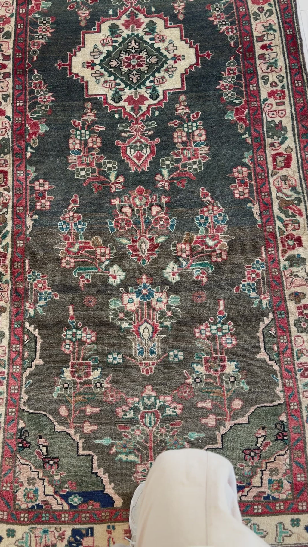 Detailed view of the Hand-Knotted Vintage Wool Runner Rug – 9' 7" x 3' 7" highlighting symmetrical floral designs and rich color variations.