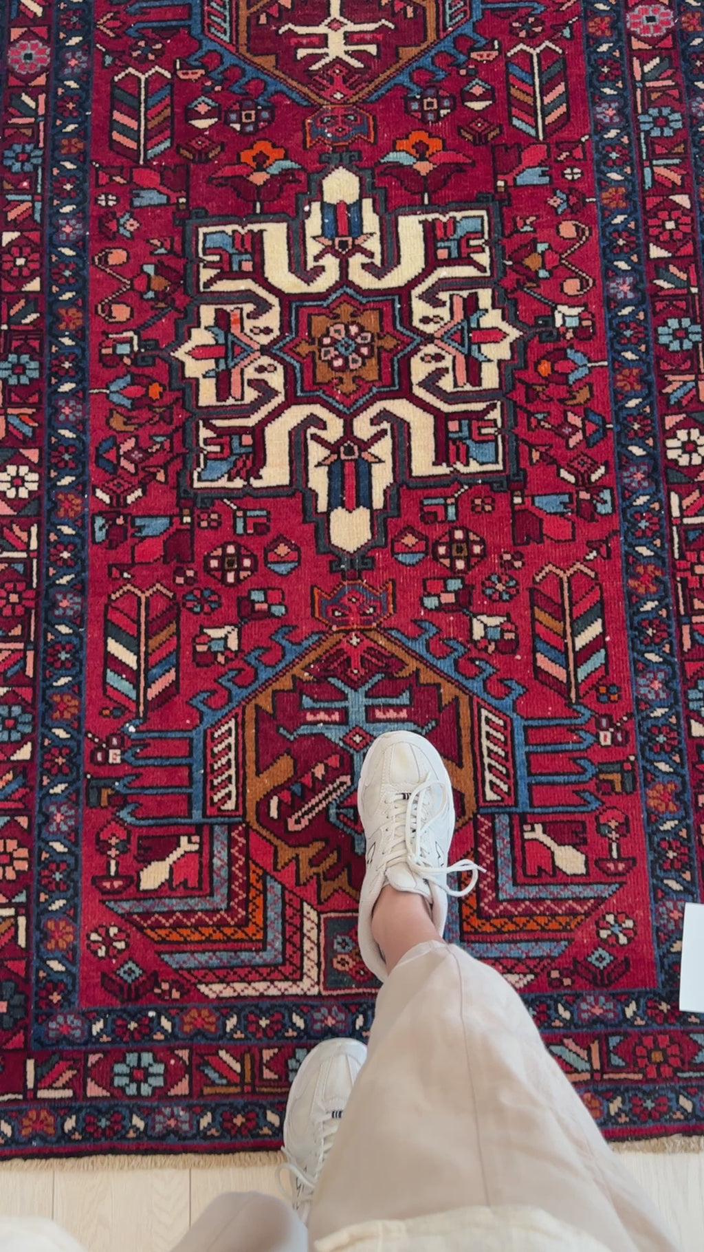 Close-up of feet on Hand-Knotted Vintage Wool Runner Rug – 12' 8" x 3' 3", emphasizing the detailed central medallion and rich wool texture.