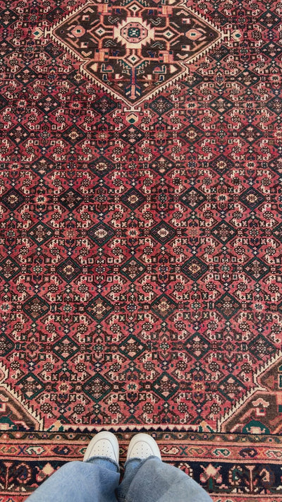 Close-up view of the Hand-Knotted Vintage Persian 5x10 Red Tribal Area Rug pattern, highlighting the rich red tones and tribal motifs.
