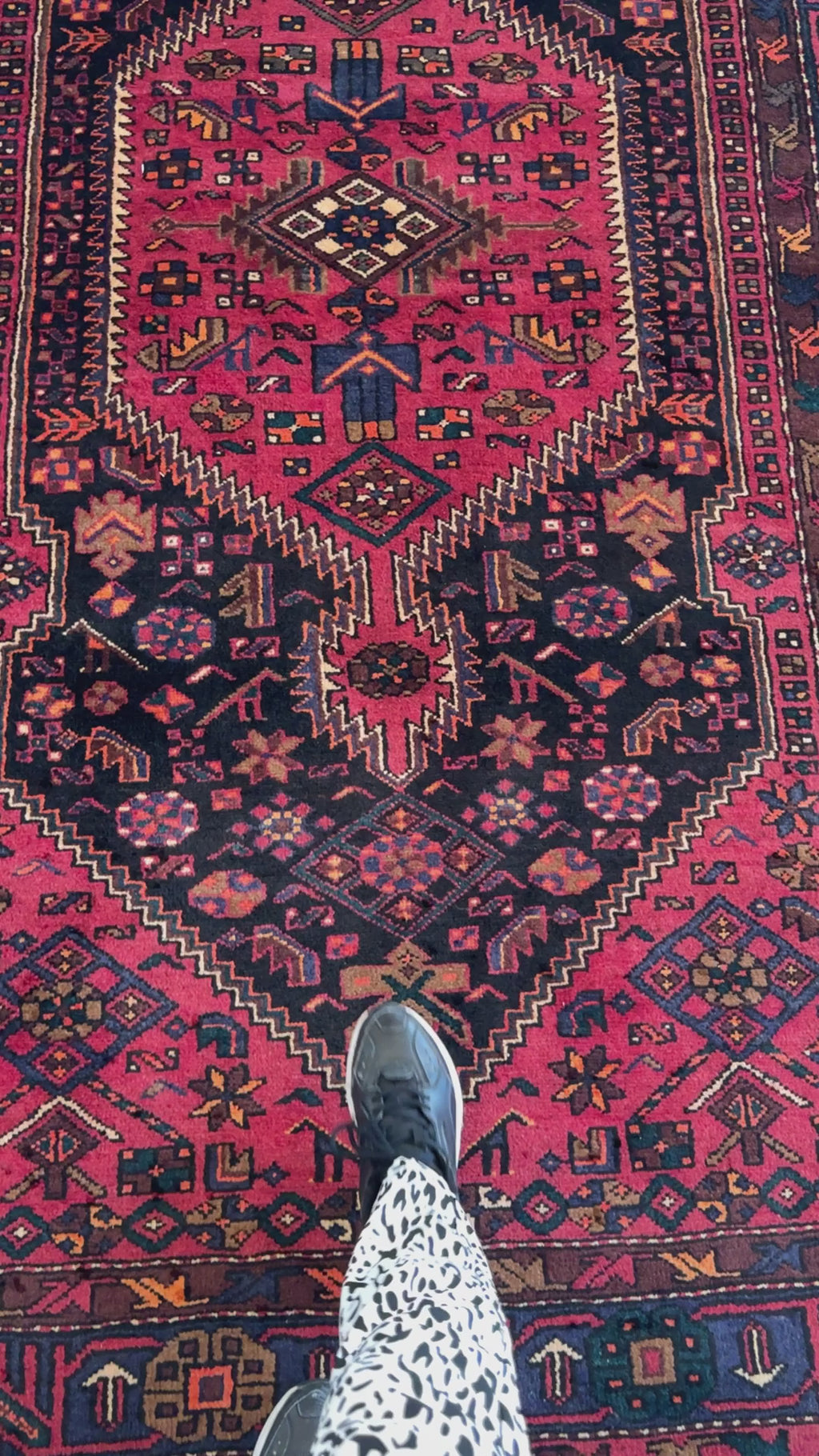 Close-up view of Hand-Knotted Vintage Wool Area Rug – 8' 11" x 5' 1" with foot for scale, highlighting detailed geometric motifs and rich colors.