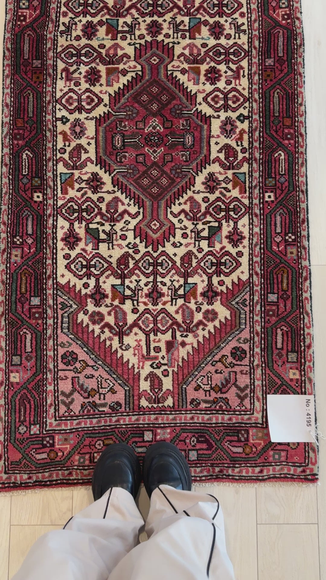 Close-up of Hand-Knotted Vintage Wool Runner Rug – 10' 11" x 2' 7" showing fine red and ivory motifs with person’s feet for scale.
