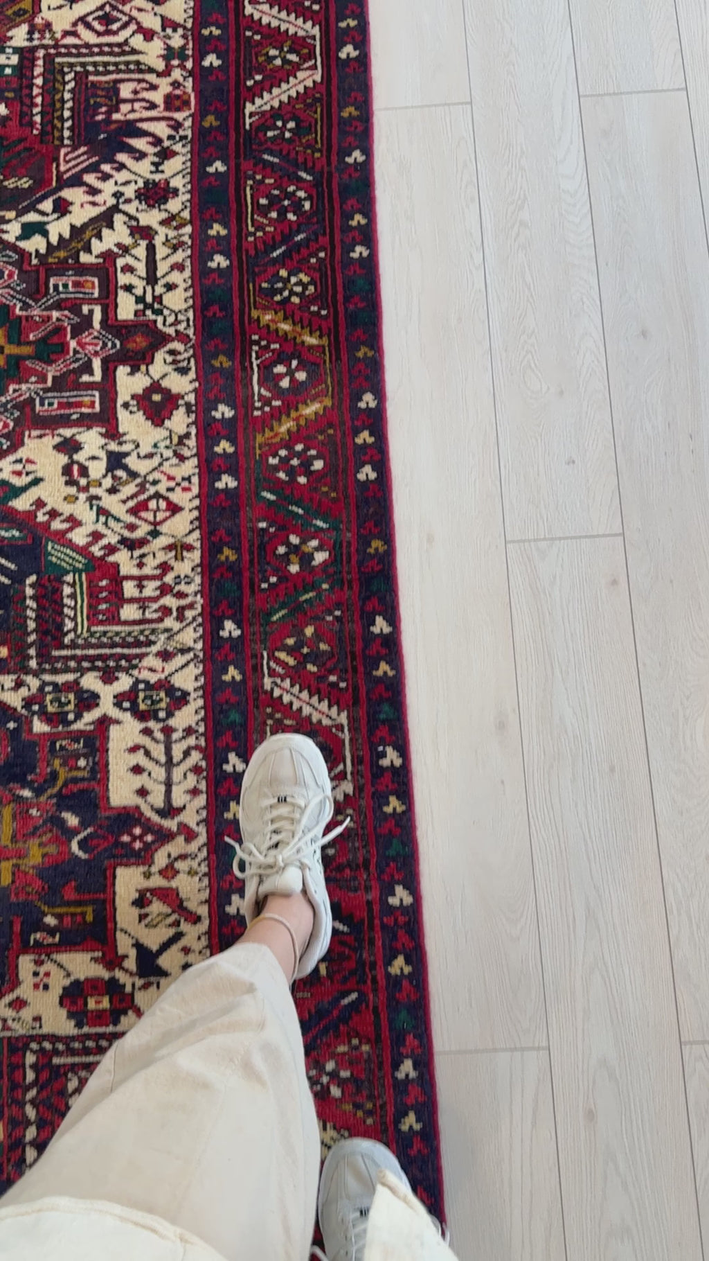 Close-up of Hand-Knotted Vintage Wool Runner Rug – 10' 11" x 3' 5" showing detailed border patterns and texture next to a person’s foot for scale.