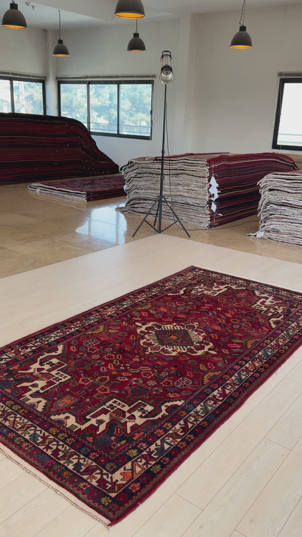 Hand-Knotted Vintage Wool Area Rug – 9' 11" x 5' 2" laid out in a spacious showroom with natural lighting, highlighting its bold central medallion design.