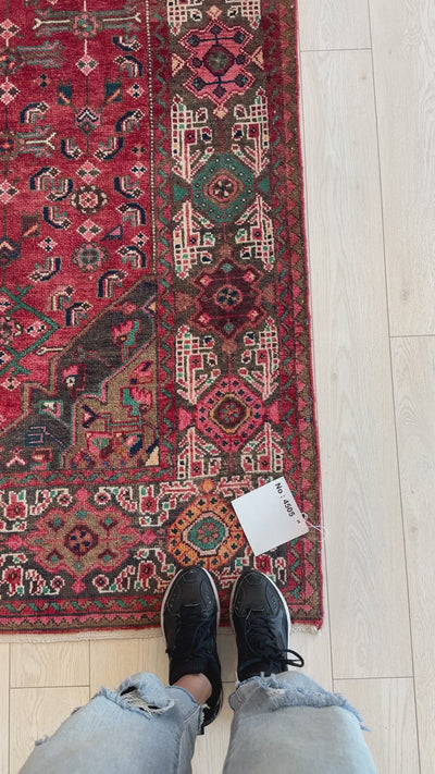 Close-up of hand-knotted vintage wool rug 10' 2" x 5' 3" showing detailed border design and texture, perfect for home and garden decor.