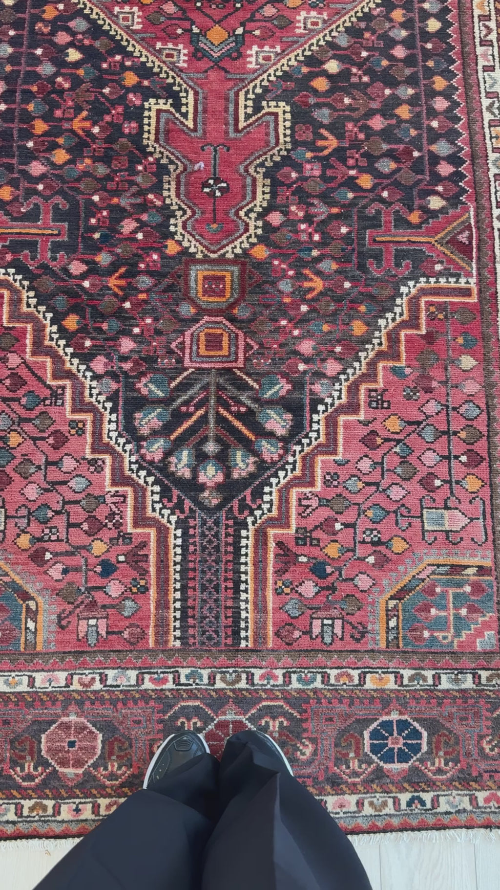 Detailed view of the lower section of the Hand-Knotted Vintage Wool Area Rug – 11' 8" x 5' 1" showing complex motifs and rich color palette.