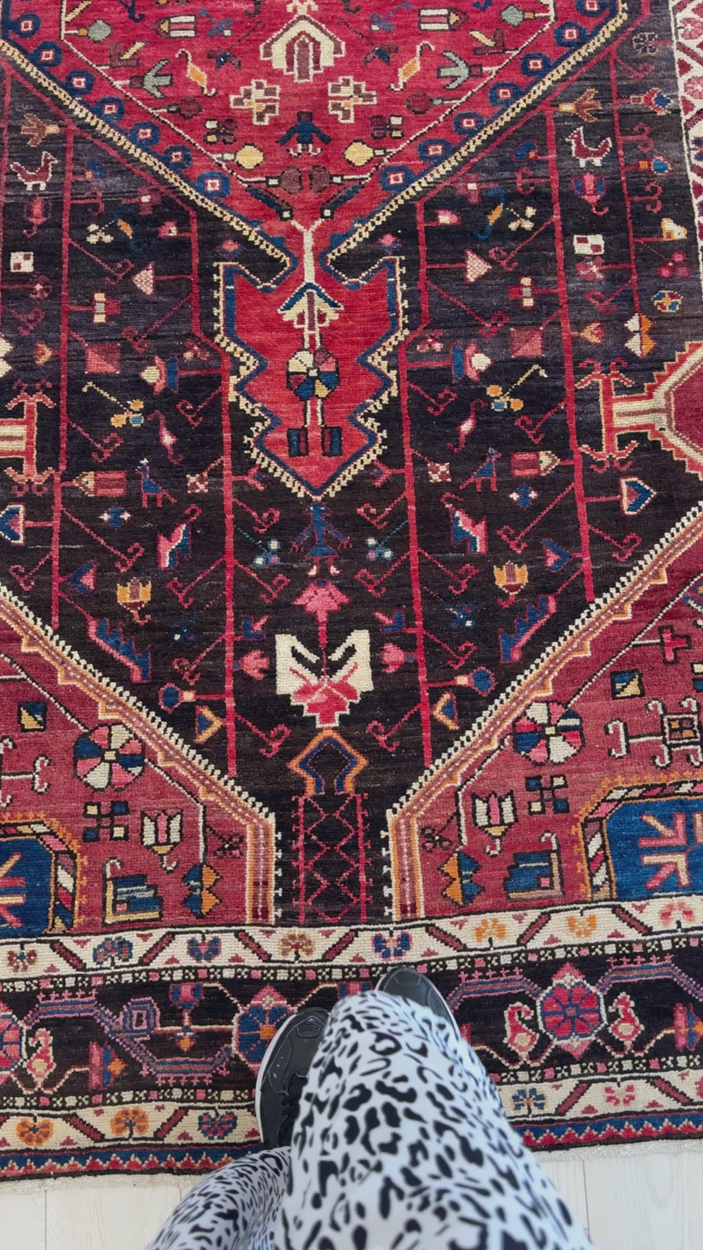 Close-up of Hand-Knotted Vintage Wool Area Rug – 10' 5" x 5' highlighting the geometric motifs and deep red and black tones in the central design.