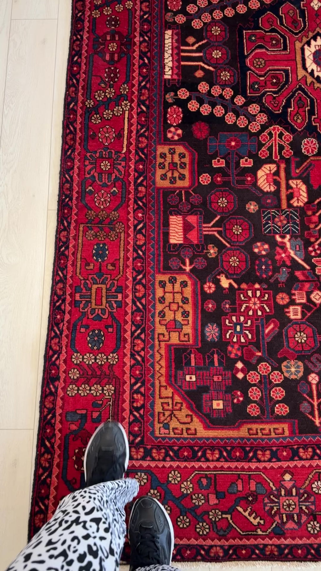 Close-up of corner design on Hand-Knotted Vintage Wool Area Rug – 9' 4" x 5' with floral and tribal patterns in red and navy tones.