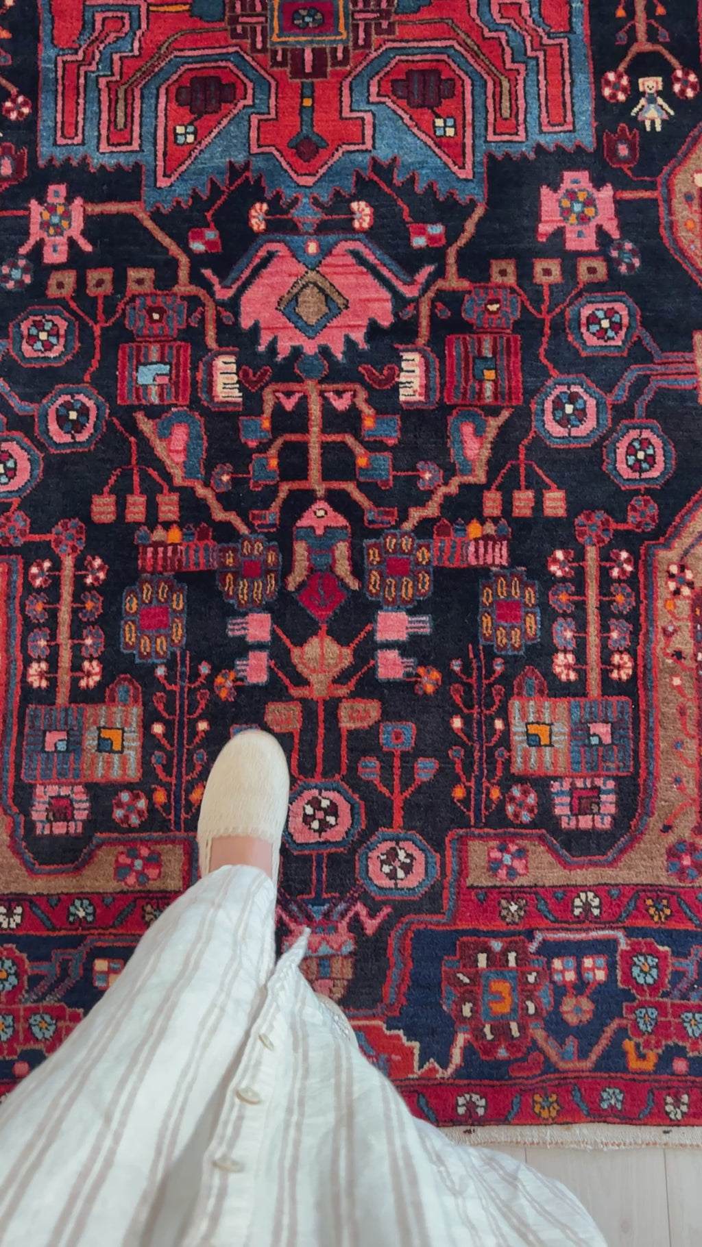 Close-up of foot on Hand-Knotted Vintage Wool Area Rug – 8' 9" x 5' 1" highlighting detailed wool texture and vibrant tribal design.