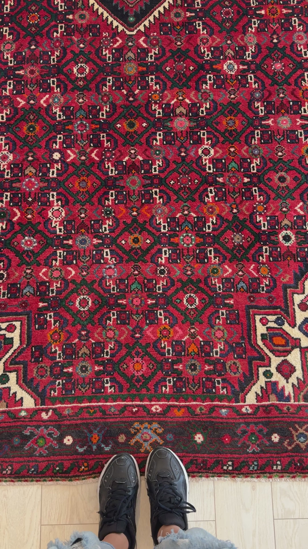 Close-up of Hand-Knotted Vintage Wool Area Rug – 10' 10" x 5' 3" showing detailed red and black geometric patterns and fine craftsmanship.