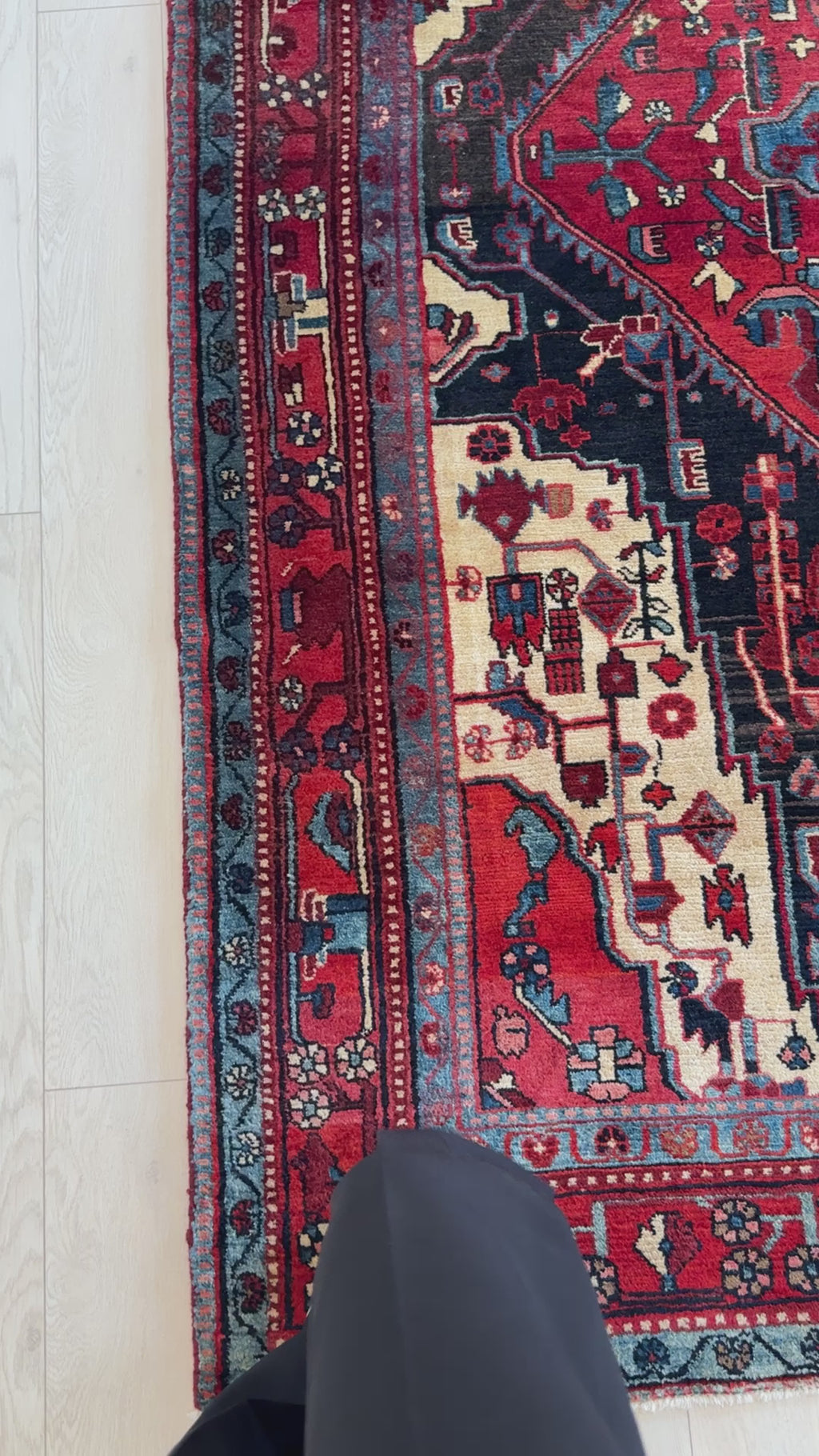 Close-up of border design on Hand-Knotted Vintage Wool Area Rug – 8' 6" x 5' 4", featuring floral motifs in red, blue, and ivory tones.