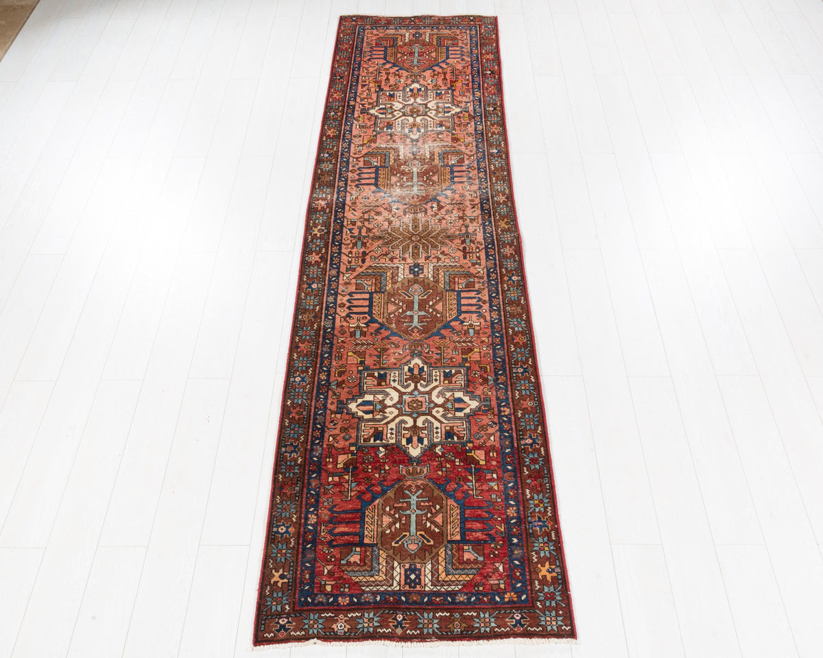 Antique Gharajeh Heriz narrow runner with faded red field, geometric medallions and worn low pile, SKU 5141