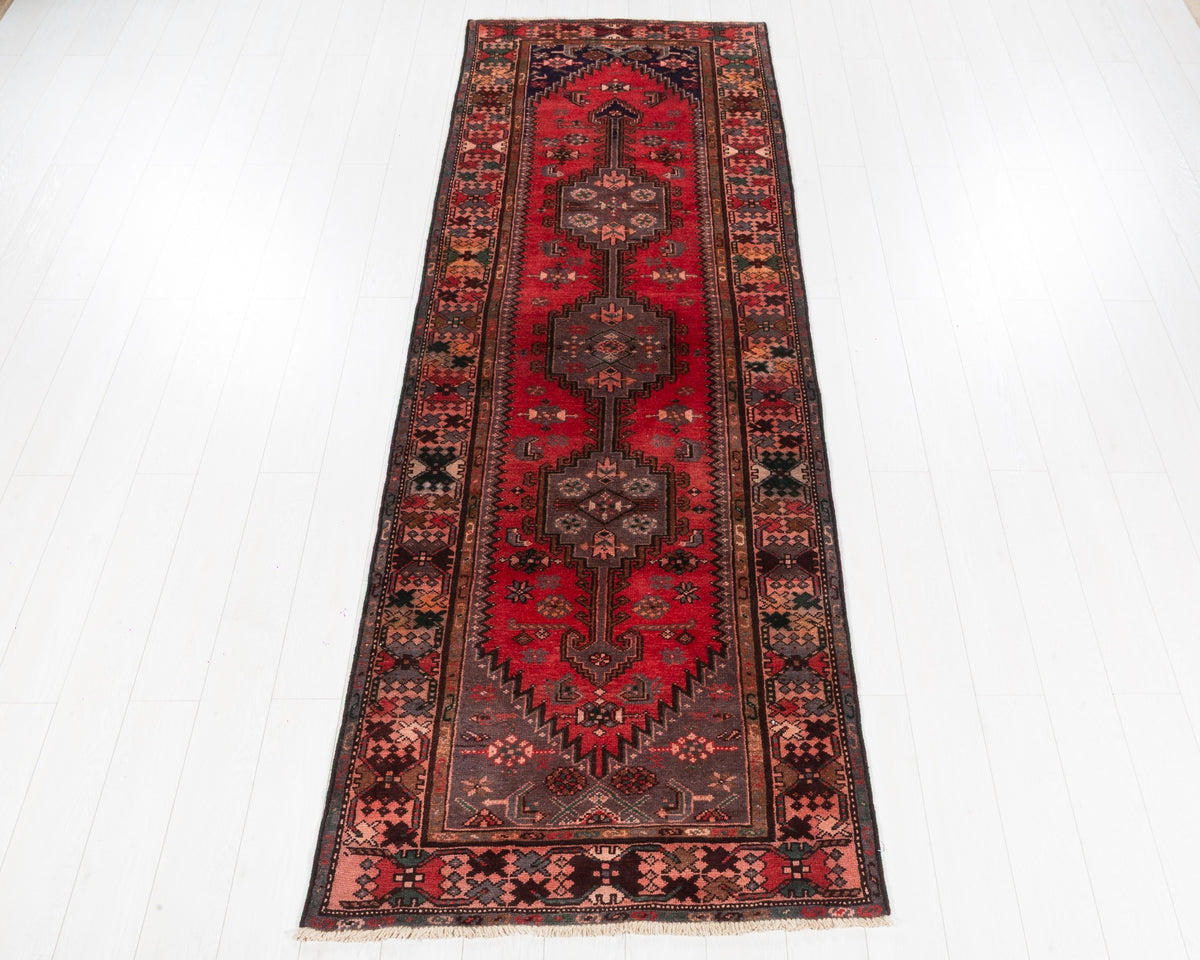 Semi-antique Zanjan runner with red field, plum-brown medallions and salmon pink geometric border, SKU 5144