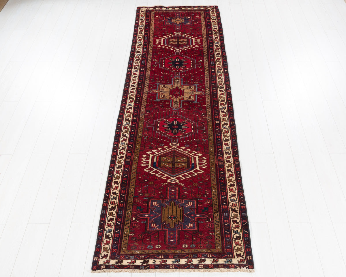 Vintage Gharajeh Heriz runner with red field, varied geometric medallions, brown and navy details, SKU 5147